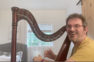 Etienne playing playing his harp